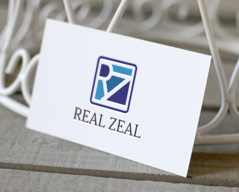 不動産の開発会社「REAL ZEAL」(リアルジール)の企業ロゴ
